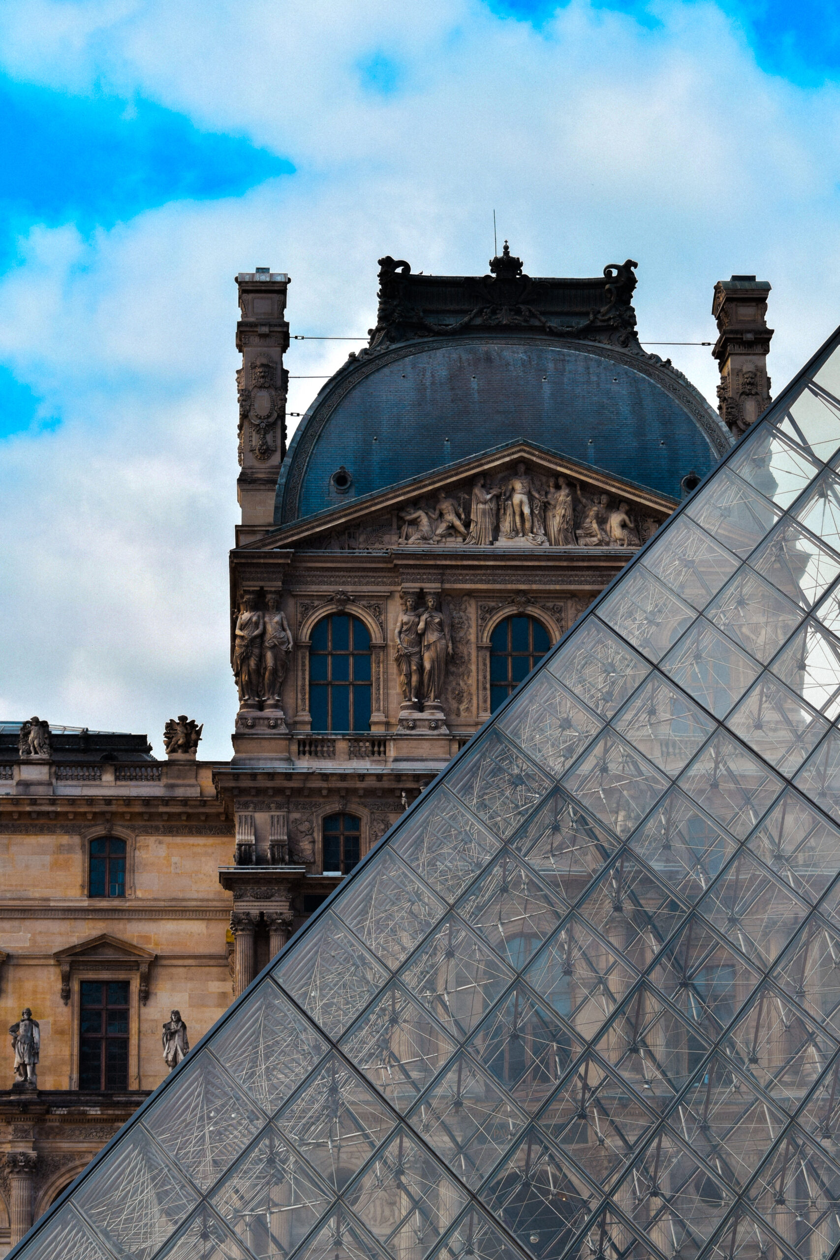 Louvre triangle in the foreground and the palace in the foreground
